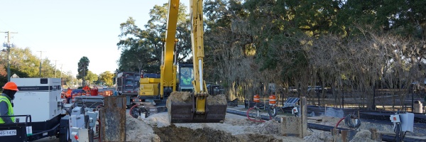 An excavator removes a bucket of dirt from a tunnel pit location on South Kings Avenue just north of Bloomingdale Avenue.